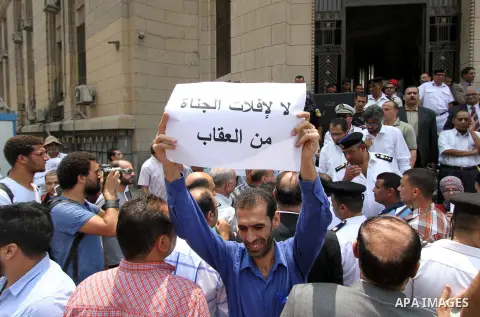 Egyptian Christians hold banners during a protest against Copts in Minya, in front of the High Court in Cairo, Egypt, on August 13, 2016. Photo by Amr Sayed