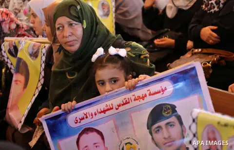 Palestinians take part in a protest demanding release the prisoners in Israeli jails, in front of Red cross office, in Gaza city on August 15, 2016. Photo by Mohammed Asad