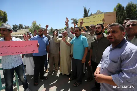 Palestinians from the Al-Bureij refugee camp, take part in protest demanding their rights, in Gaza city, on August 16, 2016. Photo by Mohammed Asad