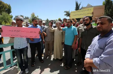 Palestinians from the Al-Bureij refugee camp, take part in protest demanding their rights, in Gaza city, on August 16, 2016. Photo by Mohammed Asad