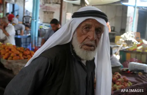 Palestinians shop at a market in Rafah in the southern Gaza strip, on August 16, 2016. Photo by Abed Rahim Khatib