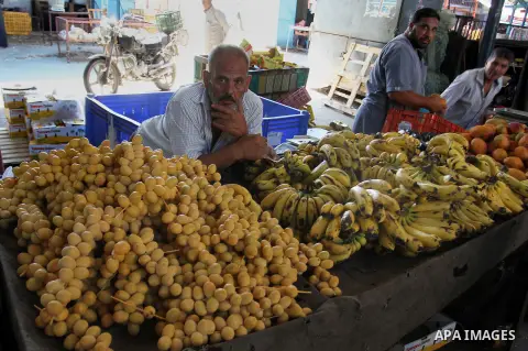 Palestinians shop at a market in Rafah in the southern Gaza strip, on August 16, 2016. Photo by Abed Rahim Khatib
