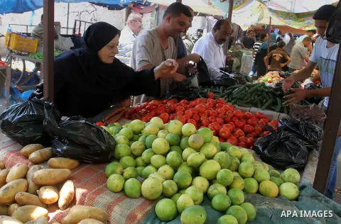 Palestinians shop at a market in Rafah in the southern Gaza strip, on August 16, 2016. Photo by Abed Rahim Khatib