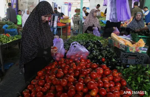 Palestinians shop at a market in Rafah in the southern Gaza strip, on August 16, 2016. Photo by Abed Rahim Khatib