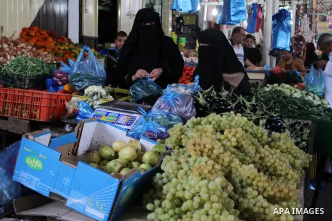 Palestinians shop at a market in Rafah in the southern Gaza strip, on August 16, 2016. Photo by Abed Rahim Khatib
