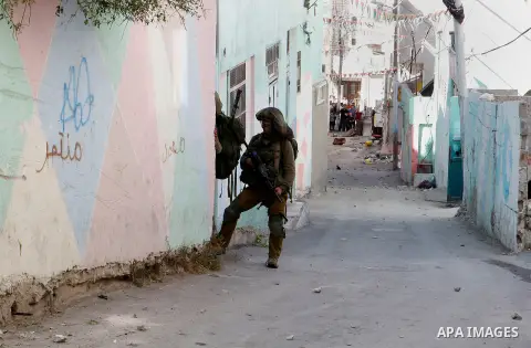 Israeli soldiers conduct searches in the Palestinian al-Fawwar refugee camp, south of the West Bank city of Hebron, on August 16, 2016. Twenty-five Palestinians were wounded in clashes with Israeli soldiers conducting se...