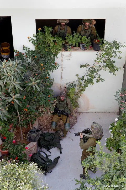 Israeli soldiers conduct searches in the Palestinian al-Fawwar refugee camp, south of the West Bank city of Hebron, on August 16, 2016. Twenty-five Palestinians were wounded in clashes with Israeli soldiers conducting se...