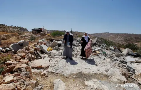 Palestinians check their belongings after Israeli troops demolished their house in the West Bank village of Saeer, near Hebron August 16, 2016. Photo by Wisam Hashlamoun