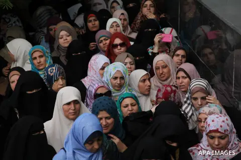 Employees of former Palestinian government in Gaza Strip wait to receive their salaries at a Post Office in Gaza city on August 17, 2016. The Emir of Qatar, Sheikh Tamim bin Hamad al-Thani, has ordered paying a total of...