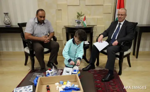 Palestinian Prime Minister, Rami Hamdallah meets with Ahmed Dawabsha, who suffered severe burns in an arson attack by suspected Jewish attackers on his family home last year in which his younger brother, Ali, and his par...