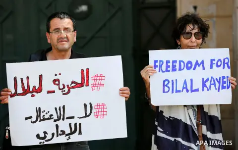 Palestinians hold posters against administrative detention and in support of Palestinian prisoner Bilal Kayed (portrait), who has been fasting for almost two months over his detention without trial, in the West Bank city...