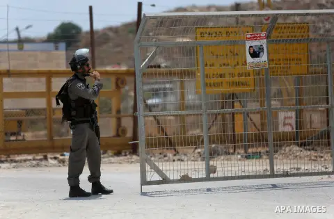 An Israeli soldier takes position during clashes with Palestinian protesters following a protest in solidarity with Palestinian prisoners held in Israeli jails, near Israel's Ofer Prison near the West Bank city of Ramall...
