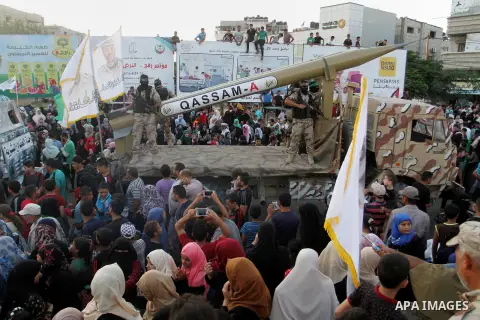 Palestinian members of al-Qassam Brigades, the armed wing of the Hamas movement, display home-made rockets during an anti-Israel military parade, in Rafah in the southern Gaza Strip August 21, 2016. Photo by Abed Rahim K...