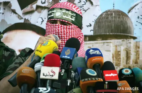 Spokesman of al-Qassam Brigades, the military wing of Hamas movement, Abu Obeida speaks during an anti-Israel military parade staged by members of al-Qassam Brigades, the armed wing of the Hamas movement, in Rafah in the...