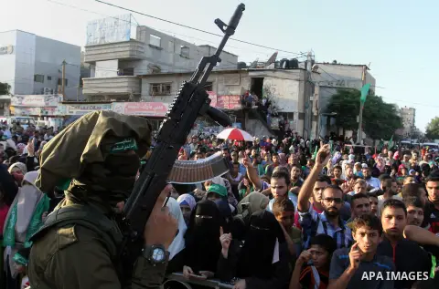 Palestinians supporting Hamas chant slogans during an anti-Israel military parade staged by members of al-Qassam Brigades, the armed wing of the Hamas movement, in Rafah in the southern Gaza Strip August 21, 2016. Photo...
