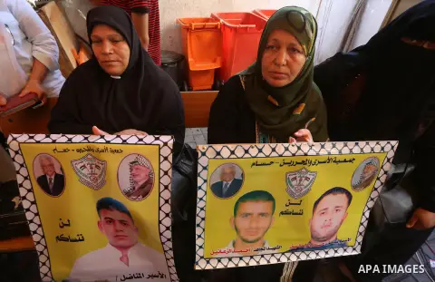 Palestinians take part in a protest demanding release the prisoners in Israeli jails, in front of Red cross office in Gaza city, on August 22, 2016. Photo by Mohammed Asad