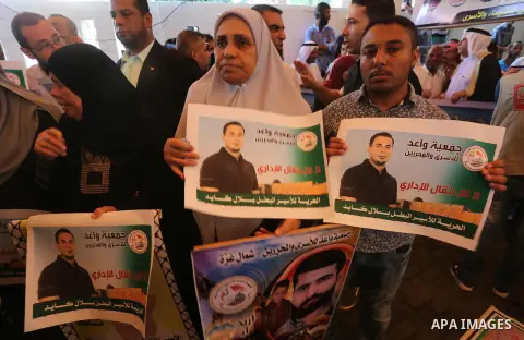Palestinians take part in a protest demanding release the prisoners in Israeli jails, in front of Red cross office in Gaza city, on August 22, 2016. Photo by Mohammed Asad