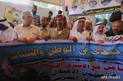 Palestinians take part in a protest demanding release the prisoners in Israeli jails, in front of Red cross office in Gaza city, on August 22, 2016. Photo by Mohammed Asad