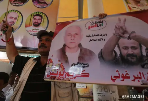 Palestinians take part in a protest demanding release the prisoners in Israeli jails, in front of Red cross office in Gaza city, on August 22, 2016. Photo by Mohammed Asad