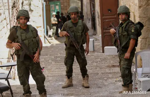 Members of the Palestinian security forces patrol in the West Bank city of Nablus on August 22, 2016 during ongoing clashes between the security forces and Palestinian gunmen. Palestinian security forces detained two Nab...