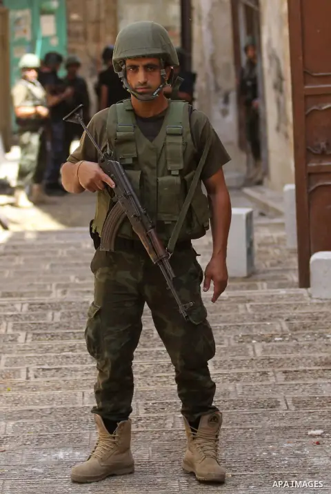 Members of the Palestinian security forces patrol in the West Bank city of Nablus on August 22, 2016 during ongoing clashes between the security forces and Palestinian gunmen. Palestinian security forces detained two Nab...