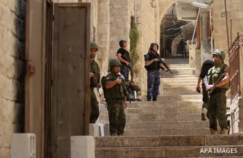Members of the Palestinian security forces patrol in the West Bank city of Nablus on August 22, 2016 during ongoing clashes between the security forces and Palestinian gunmen. Palestinian security forces detained two Nab...