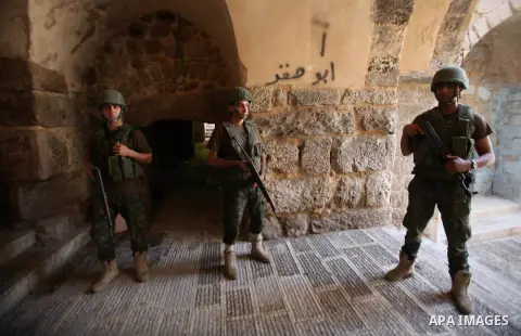 Members of the Palestinian security forces patrol in the West Bank city of Nablus on August 22, 2016 during ongoing clashes between the security forces and Palestinian gunmen. Palestinian security forces detained two Nab...