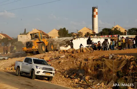 Israeli troops stand guard as bulldozers demolish houses near the West Bank village of Um AlKhair, south of Hebron August 24, 2016. Photo by Wisam Hashlamoun