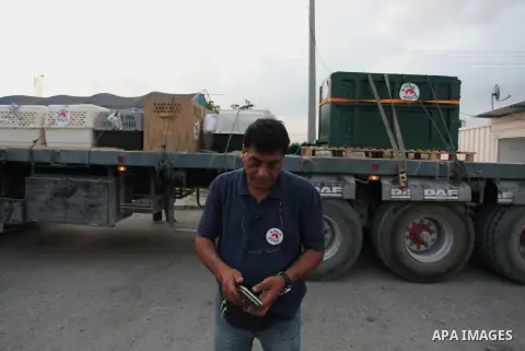 Members of the international animal welfare charity "Four Paws" transport animals across the Erez border crossing into Israel after evacuating them from the zoo in Khan Yunis in the southern Gaza Strip on August 24, 2016...