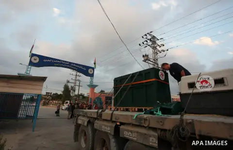 Members of the international animal welfare charity "Four Paws" transport animals across the Erez border crossing into Israel after evacuating them from the zoo in Khan Yunis in the southern Gaza Strip on August 24, 2016...