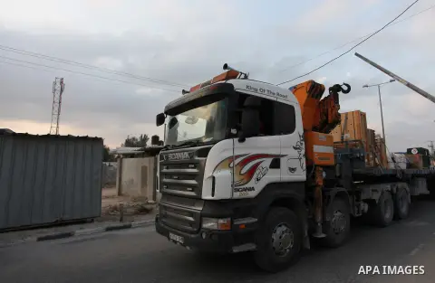 Members of the international animal welfare charity "Four Paws" transport animals across the Erez border crossing into Israel after evacuating them from the zoo in Khan Yunis in the southern Gaza Strip on August 24, 2016...