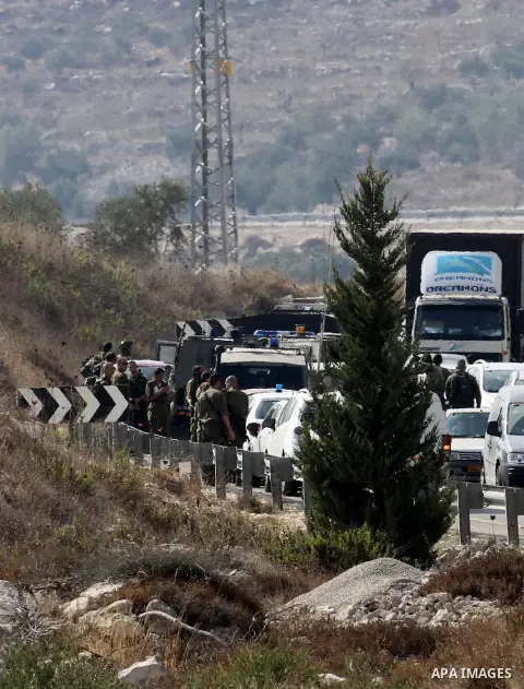Israeli security forces gather at the scene where Palestinian Sari Abu Ghrab was shot dead by Israeli troops near the West Bank village of Madama near Nablus August 24, 2016. An Israeli army statement said Israeli forces...
