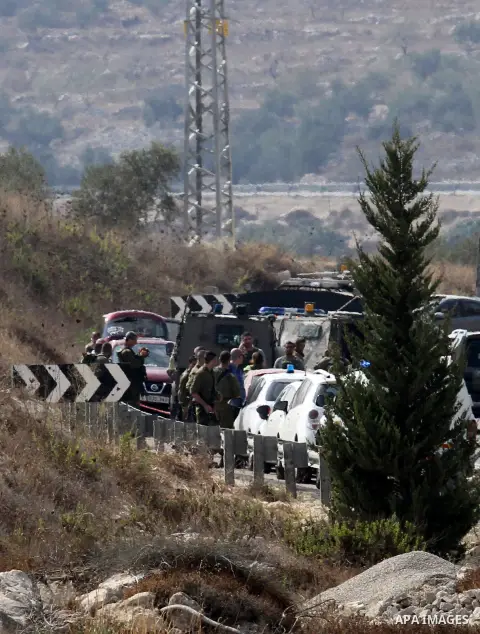 Israeli security forces gather at the scene where Palestinian Sari Abu Ghrab was shot dead by Israeli troops near the West Bank village of Madama near Nablus August 24, 2016. An Israeli army statement said Israeli forces...