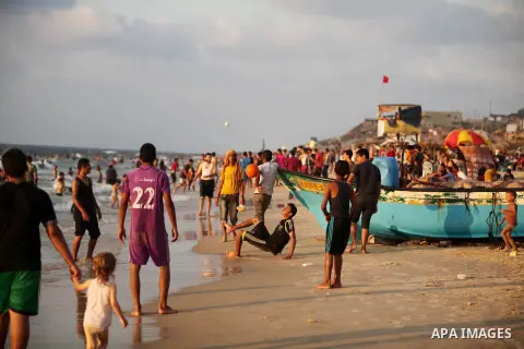 Palestinian children enjoy a day at the beach in Deir Al Balah in the center of Gaza strip at the last Friday of summer holiday, on Aug. 26, 2016. Photo by Ashraf Amra