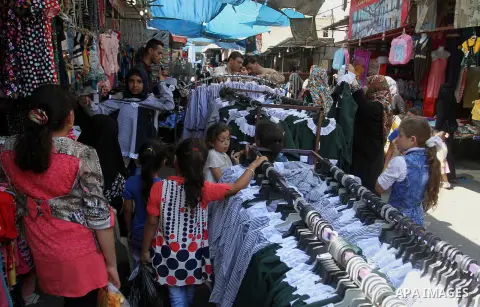 Palestinians shop during preparation for the new school year at a market in Rafah in the southern Gaza strip on August 27, 2016. Photo by Abed Rahim Khatib