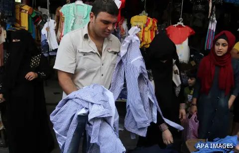 Palestinians shop during preparation for the new school year at a market in Rafah in the southern Gaza strip on August 27, 2016. Photo by Abed Rahim Khatib