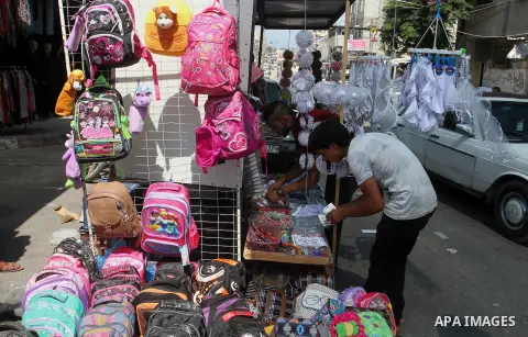 Palestinians shop during preparation for the new school year at a market in Rafah in the southern Gaza strip on August 27, 2016. Photo by Abed Rahim Khatib