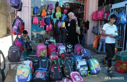 Palestinians shop during preparation for the new school year at a market in Rafah in the southern Gaza strip on August 27, 2016. Photo by Abed Rahim Khatib