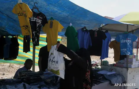 Palestinians shop during preparation for the new school year at a market in Rafah in the southern Gaza strip on August 27, 2016. Photo by Abed Rahim Khatib