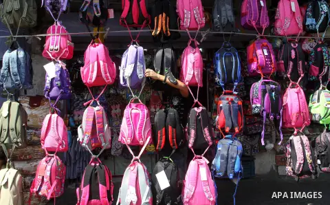 Palestinians shop during preparation for the new school year at a market in Rafah in the southern Gaza strip on August 27, 2016. Photo by Abed Rahim Khatib