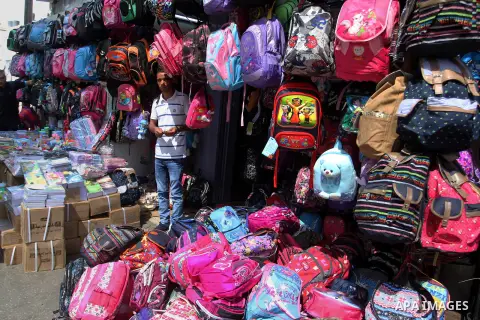 Palestinians shop during preparation for the new school year at a market in Rafah in the southern Gaza strip on August 27, 2016. Photo by Abed Rahim Khatib