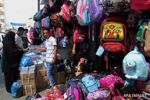 Palestinians shop during preparation for the new school year at a market in Rafah in the southern Gaza strip on August 27, 2016. Photo by Abed Rahim Khatib
