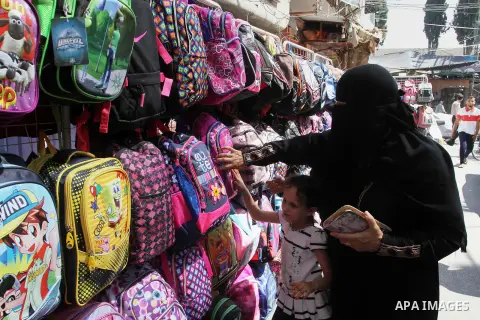 Palestinians shop during preparation for the new school year at a market in Rafah in the southern Gaza strip on August 27, 2016. Photo by Abed Rahim Khatib