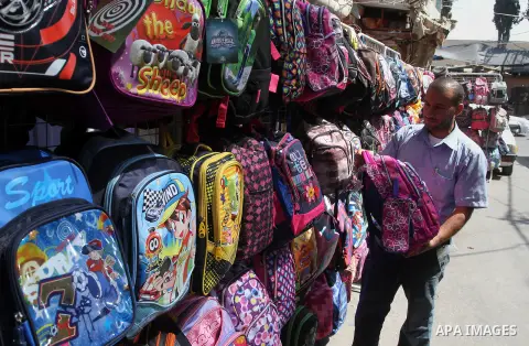 Palestinians shop during preparation for the new school year at a market in Rafah in the southern Gaza strip on August 27, 2016. Photo by Abed Rahim Khatib