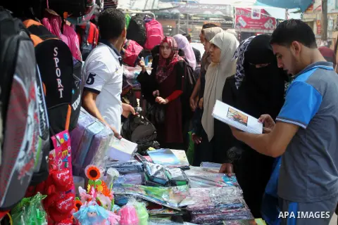 Palestinians shop during preparation for the new school year at a market in Rafah in the southern Gaza strip on August 27, 2016. Photo by Abed Rahim Khatib
