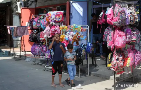 Palestinians shop during preparation for the new school year at a market in Rafah in the southern Gaza strip on August 27, 2016. Photo by Abed Rahim Khatib