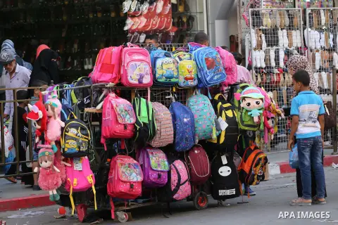 Palestinians shop during preparation for the new school year at a market in Gaza city, on August 27, 2016. Photo by Mohammed Asad