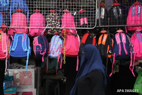 Palestinians shop during preparation for the new school year at a market in Gaza city, on August 27, 2016. Photo by Mohammed Asad