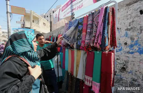 Palestinians shop during preparation for the new school year at a market in Gaza city, on August 27, 2016. Photo by Mohammed Asad