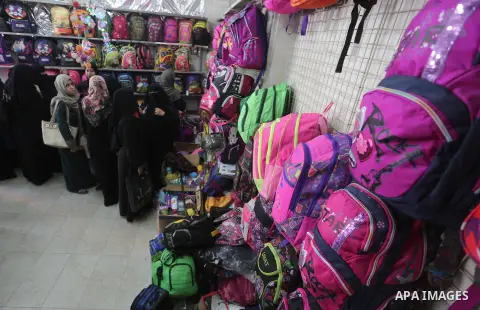Palestinians shop during preparation for the new school year at a market in Gaza city, on August 27, 2016. Photo by Mohammed Asad